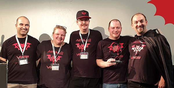 Five members of Apollo Team receiving the Amiga Community Award 2019 with a creamy wall in a background